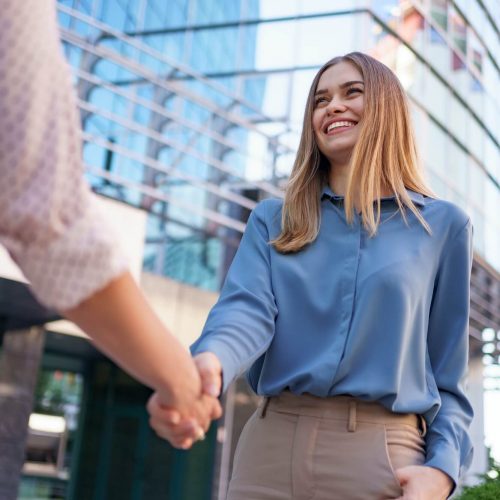 woman-hands-shake-on-business-building-background-1.jpg